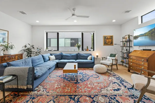 a living room with furniture and a rug