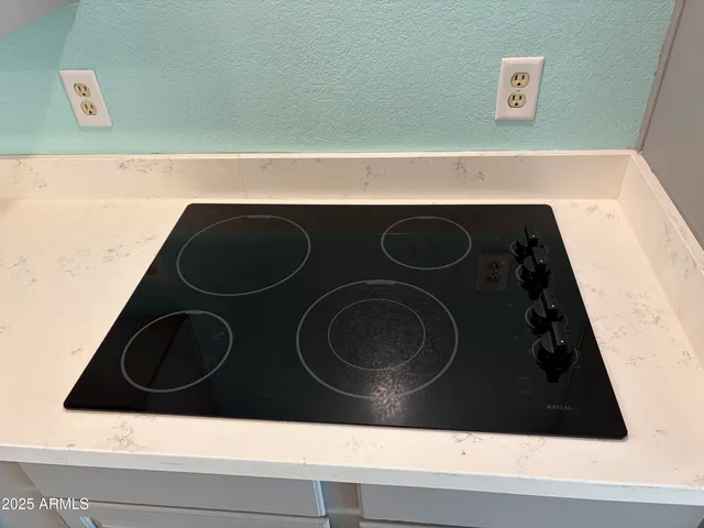 a kitchen with granite countertop a refrigerator and a sink
