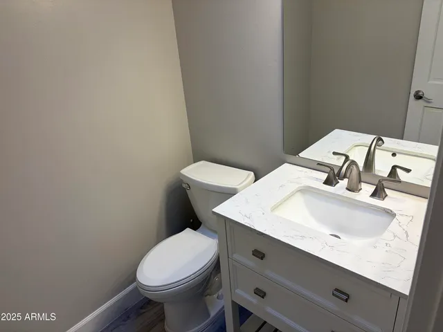 a bathroom with a sink toilet and a mirror