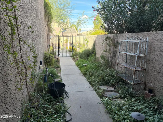 a view of a pathway both side of house