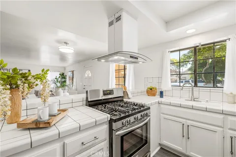 a kitchen with stove and window