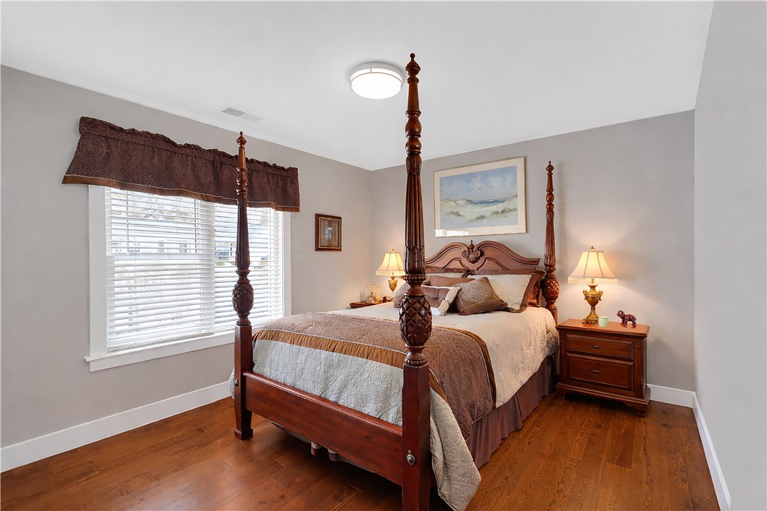 181 Amberwood Drive Anderson, SC 29621 - Photo 19 of 28 This inviting bedroom features rich hardwood flooring and ample natural light, perfect for serene living.