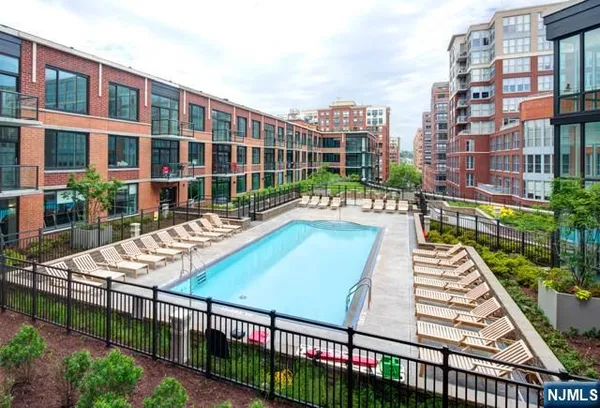 a view of building with swimming pool and outdoor seating