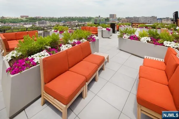a view of balcony with outdoor seating and city view