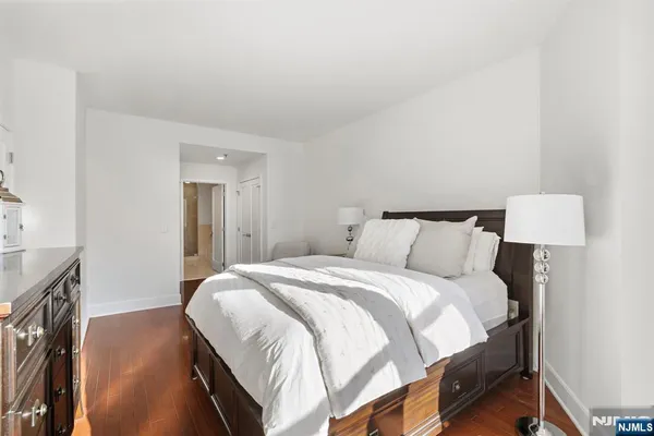 a bedroom with a bed and a night stand