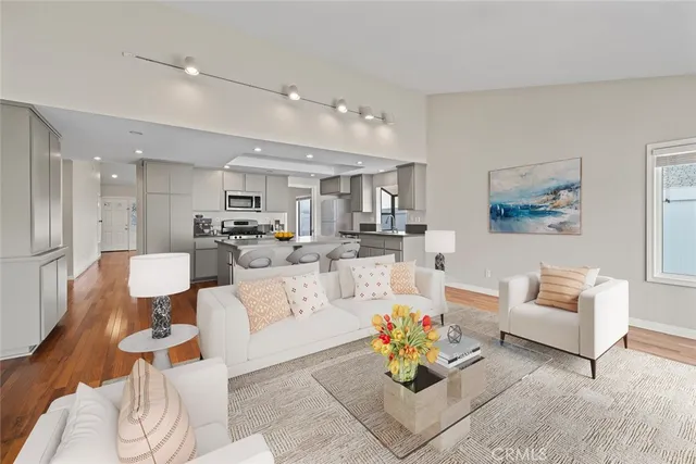 a living room with furniture and kitchen view
