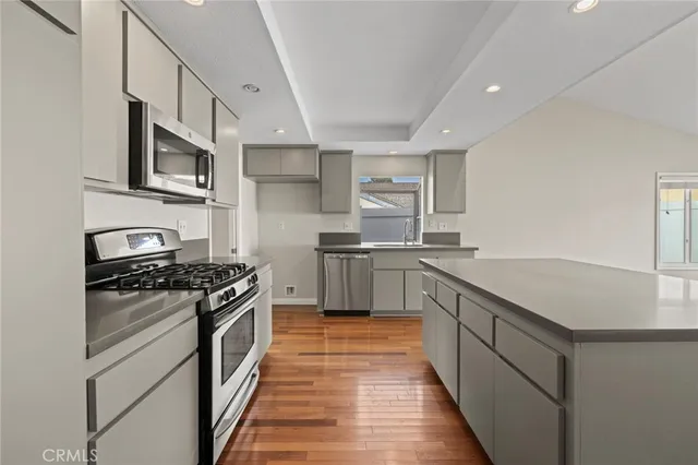 a kitchen with stainless steel appliances a sink dishwasher stove and oven