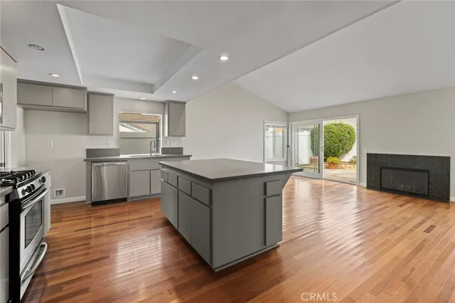a kitchen with granite countertop a sink and a stove top oven