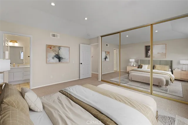 a bedroom with a bed and a large mirror
