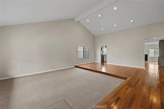 a view of a room with gym equipment and wooden floor