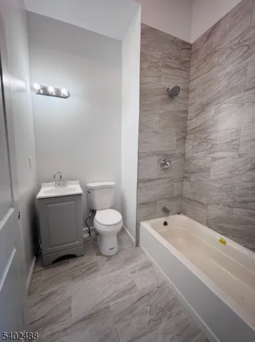 a bathroom with a sink a toilet and bathtub