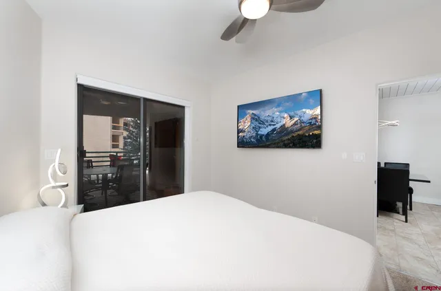 a bedroom with a bed and a large mirror