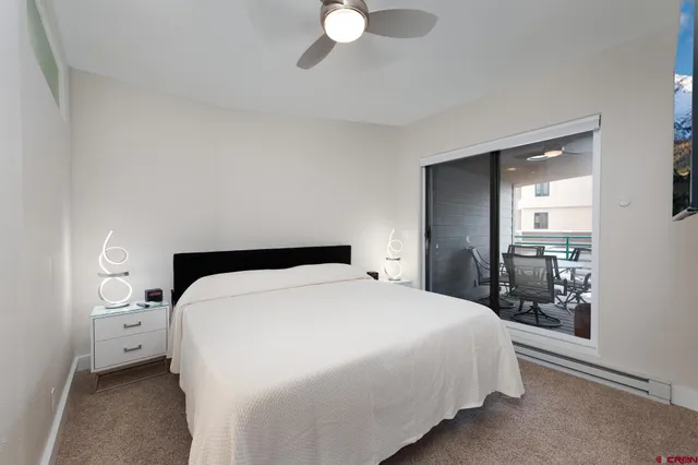 a bedroom with a bed and a large mirror