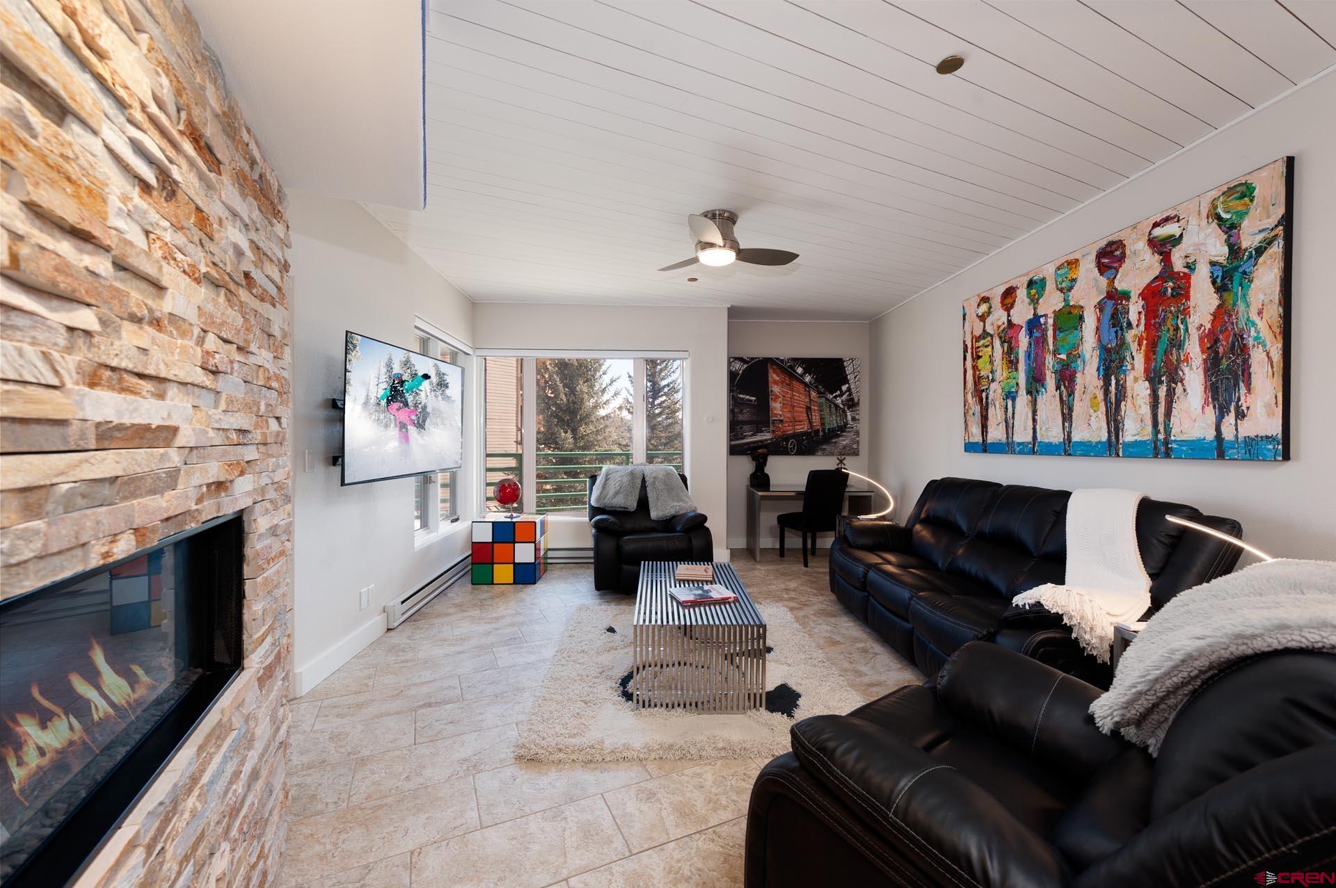 117 Needles Way, Unit 326 Durango, CO 81301 - Photo 2 of 35 a living room with furniture and a fireplace