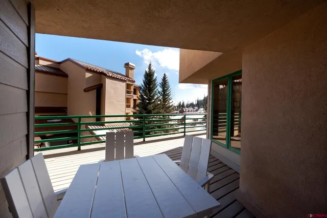 a view of a balcony with wooden floor