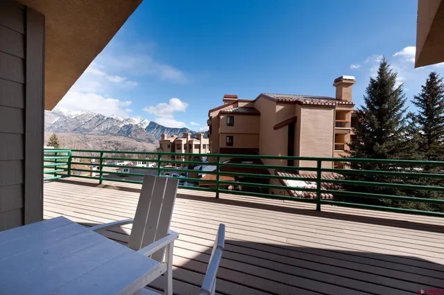 a view of a roof deck with wooden floor and fence