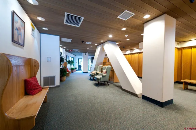 a view of a hall way with furniture