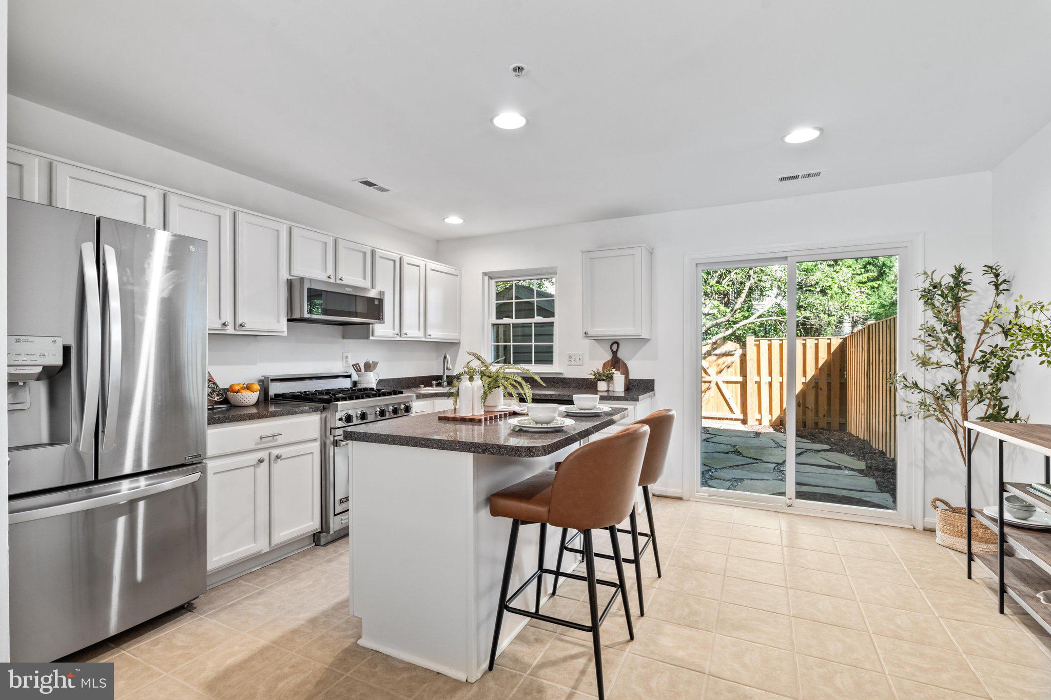 605 Hollowstone Road Frederick, MD 21703 - Photo 7 of 32 Kitchen Island/Exit to Back
