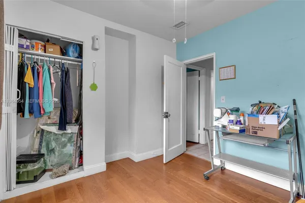 a view of a room that has a bed and a window in it