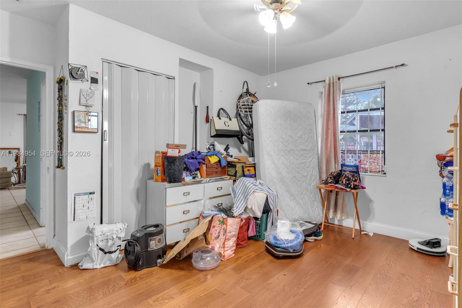 2490 Northwest 59th Street Miami, FL 33142 - Photo 14 of 37 a bedroom with furniture and a chandelier