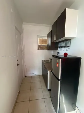 a kitchen with a refrigerator and a stove