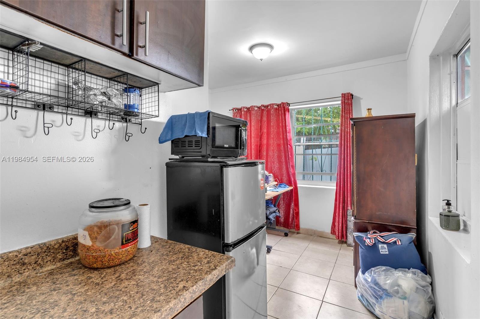 2490 Northwest 59th Street Miami, FL 33142 - Photo 26 of 37 a kitchen with a refrigerator and a stove