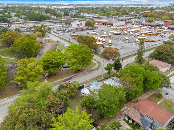 an aerial view of residential houses with outdoor space and street view