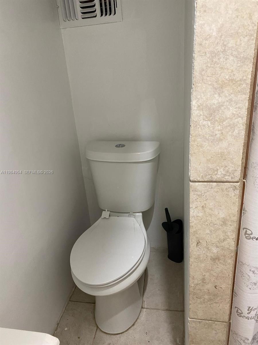 2490 Northwest 59th Street Miami, FL 33142 - Photo 30 of 37 a white toilet sitting next to a white wall