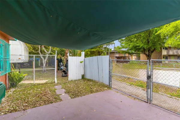a view of a backyard with large trees