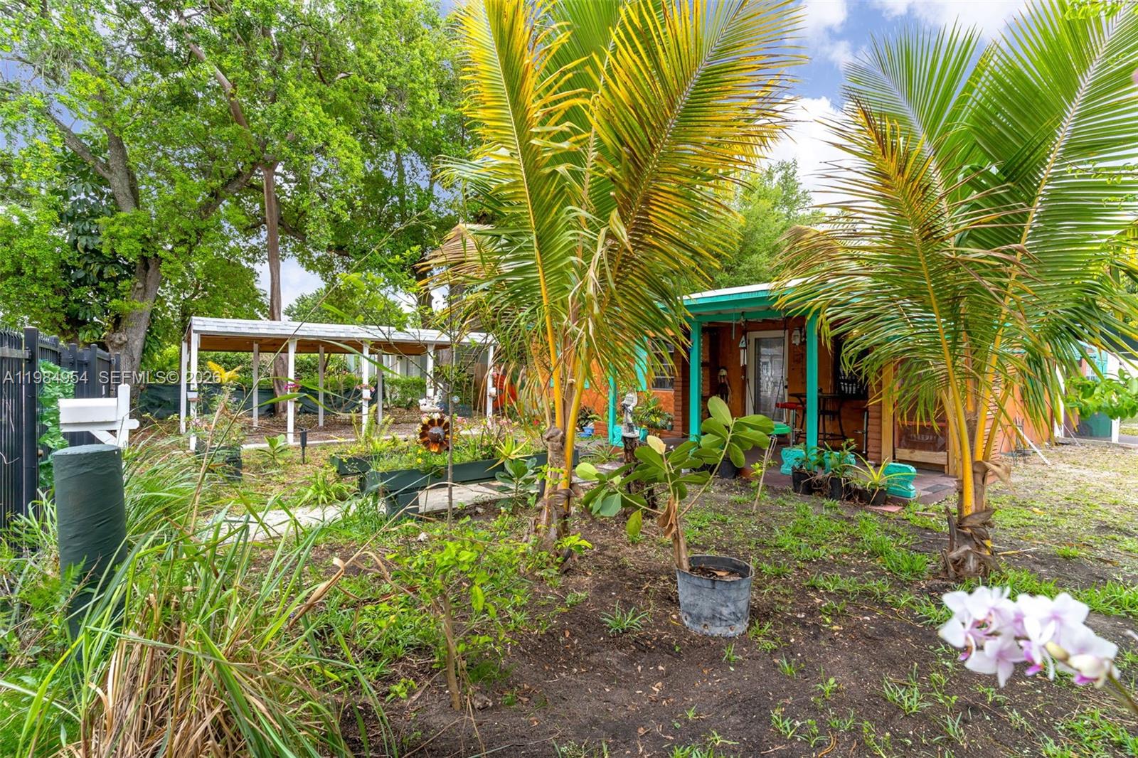 2490 Northwest 59th Street Miami, FL 33142 - Photo 3 of 37 a front view of a house with a yard