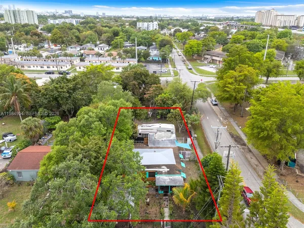 an aerial view of residential houses with outdoor space and street view