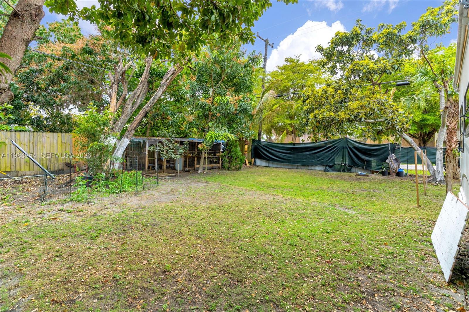 2490 Northwest 59th Street Miami, FL 33142 - Photo 33 of 37 a view of a backyard with large trees
