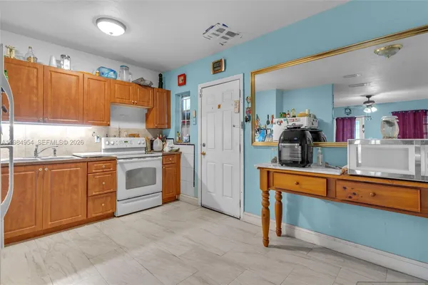 a kitchen with white cabinets and white appliances