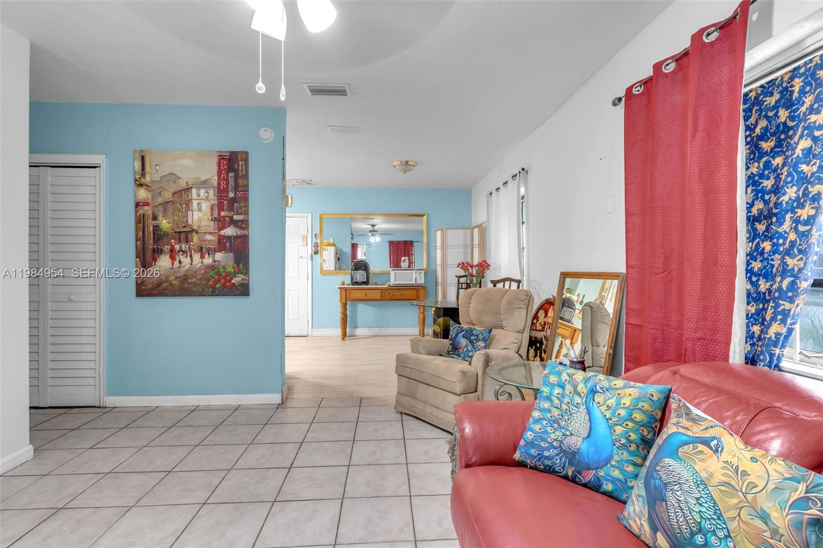 2490 Northwest 59th Street Miami, FL 33142 - Photo 7 of 37 a living room with furniture and a window