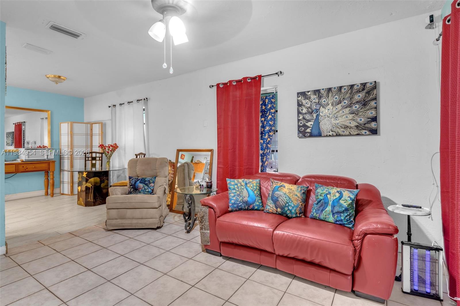 2490 Northwest 59th Street Miami, FL 33142 - Photo 9 of 37 a living room with furniture and a couch