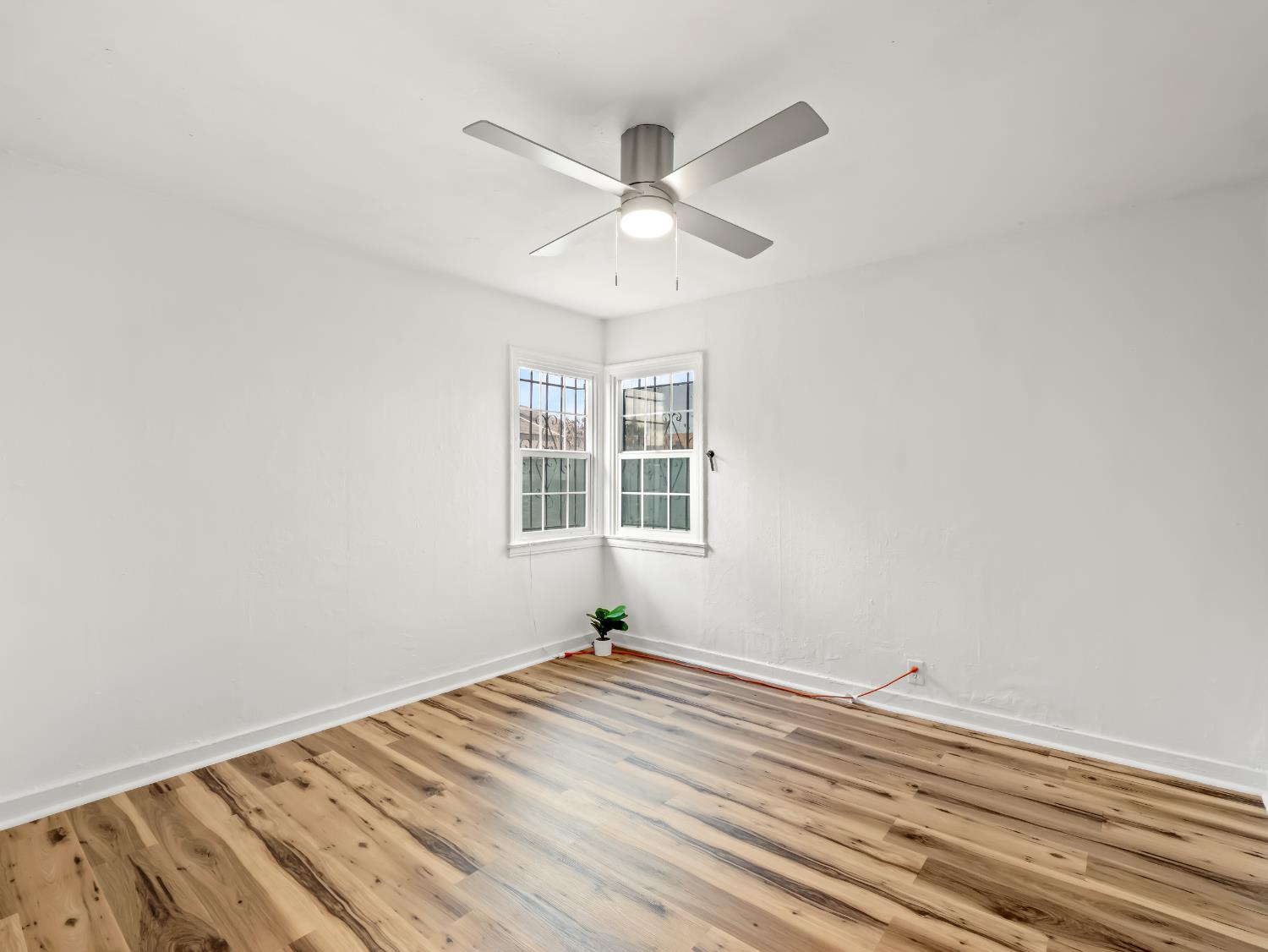 1315 North 8th Street Fresno, CA 93703 - Photo 24 of 28 a view of a room with wooden floor and a ceiling fan