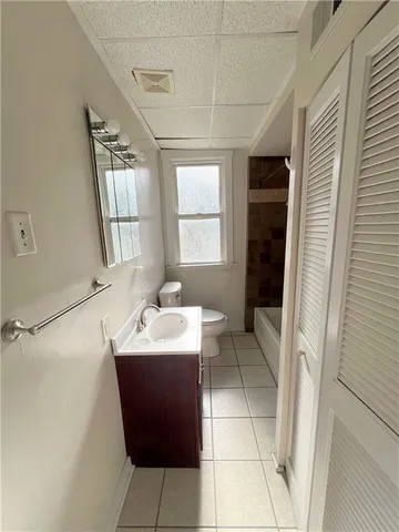 a bathroom with a sink a toilet and mirror