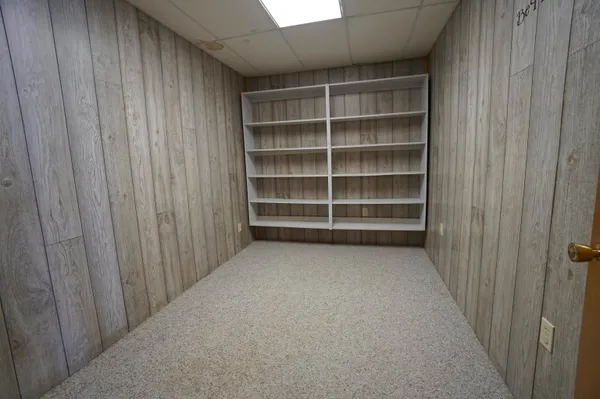 a view of empty room with ceiling fan and window