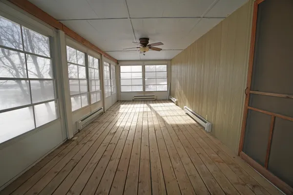 a view of wooden floor in a room next to a window