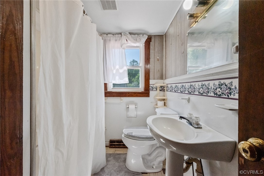 1878 Courthouse Road Louisa, VA 23093 - Photo 23 of 30 a bathroom with a sink toilet and mirror
