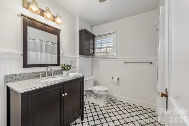 a very nice looking room with wooden floor and a chandelier