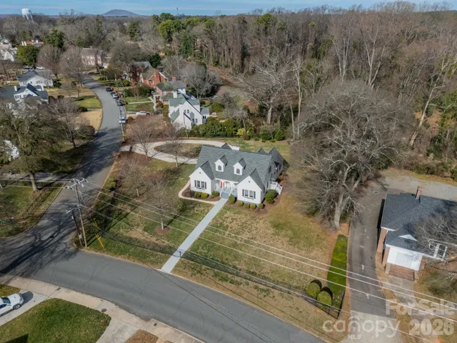 an aerial view of a residential houses with outdoor space