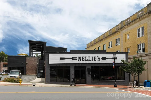a view of a brick house with a clock on the wall
