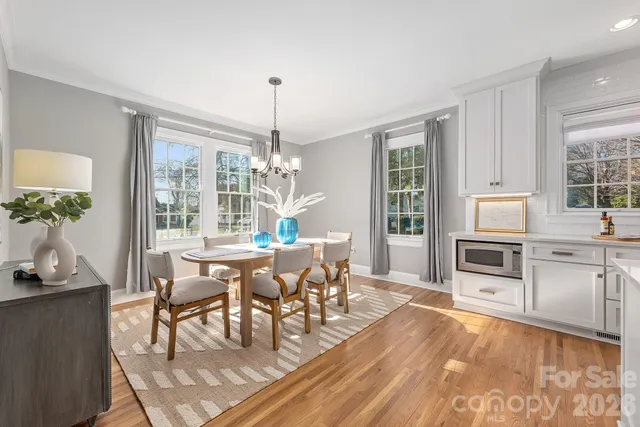 a kitchen with stainless steel appliances granite countertop a stove and a wooden floors