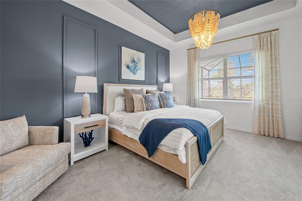 7161 Inlet Isles Lakewood Ranch, FL 34202 - Photo 17 of 29 a spacious bedroom with a bed and a chandelier