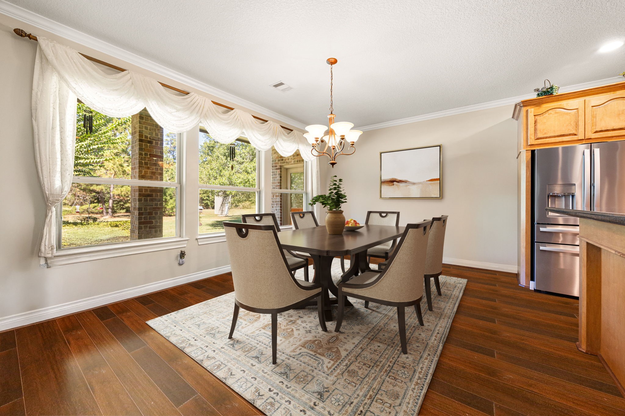 13506 Stagecoach Road Magnolia, TX 77355 - Photo 12 of 37 This elegant breakfast area is surrounded by large picture windows that fill the space with natural light and offer serene views of the backyard. Perfectly positioned off the kitchen, it provides an inviting setting for morning coffee or casual dining with family and friends.