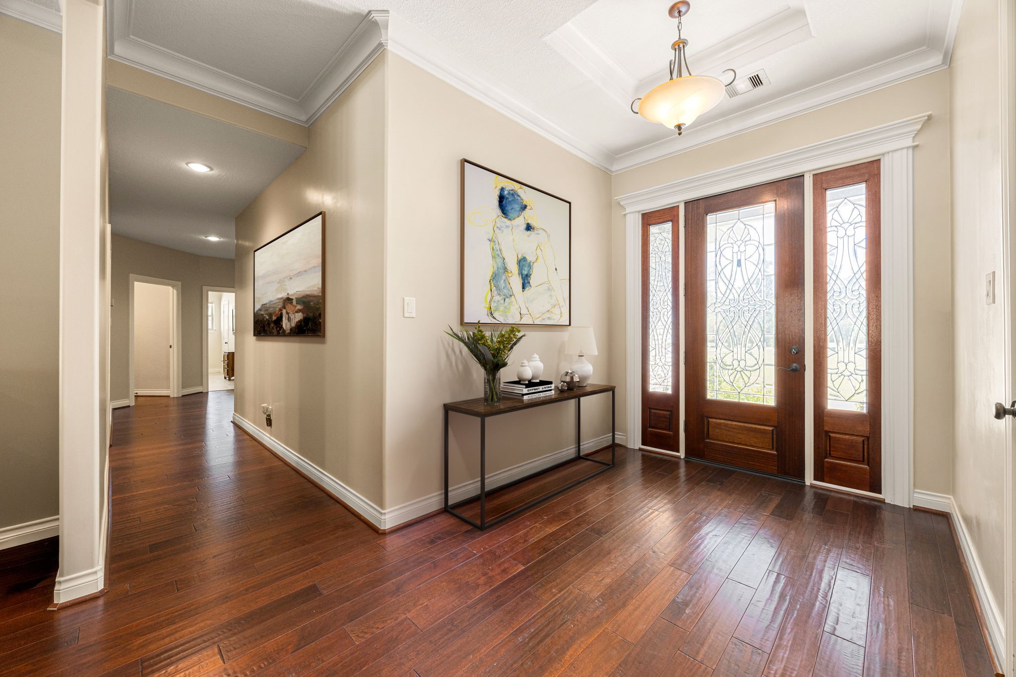 13506 Stagecoach Road Magnolia, TX 77355 - Photo 18 of 37 A welcoming entryway with rich wood flooring and elegant double doors sets the tone for this beautiful home, offering a warm first impression and a seamless flow into the main living spaces.