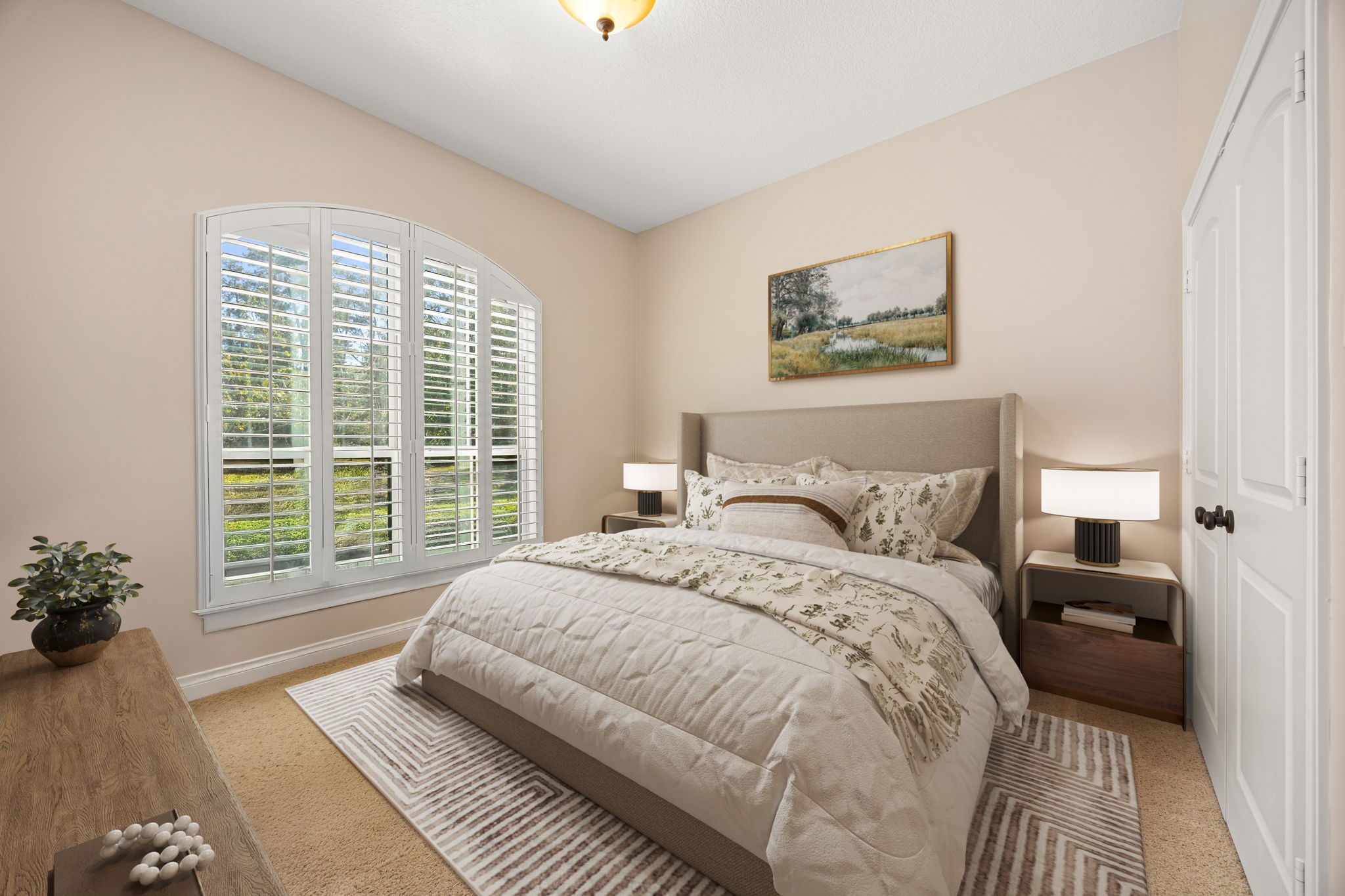 13506 Stagecoach Road Magnolia, TX 77355 - Photo 19 of 37 This inviting secondary bedroom features soft natural light, plantation shutters, and neutral tones—creating a peaceful retreat ideal for guests or family.
