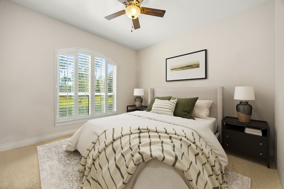 13506 Stagecoach Road Magnolia, TX 77355 - Photo 21 of 37 A bright and comfortable secondary bedroom featuring large windows with plantation shutters, soft neutral tones, and plenty of natural light, perfect for guests or family.