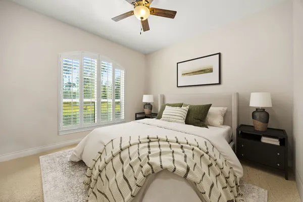 a bedroom with a large bed and a window